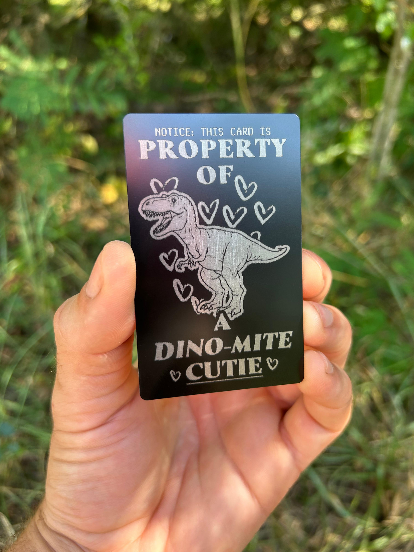 Property of a dynamite cutie play on words metal gift card, romantic -- matte black/silver on green background