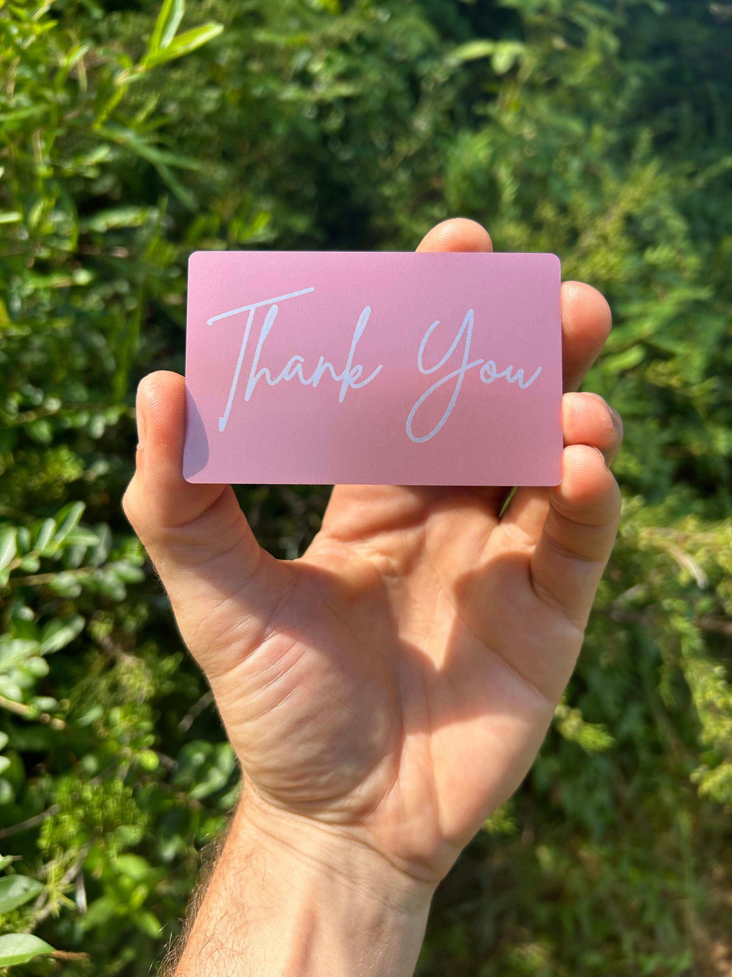 laser engraved rose gold metal gift card insert that says "Thank You" in cursive text, laser engraved on anodized aluminum