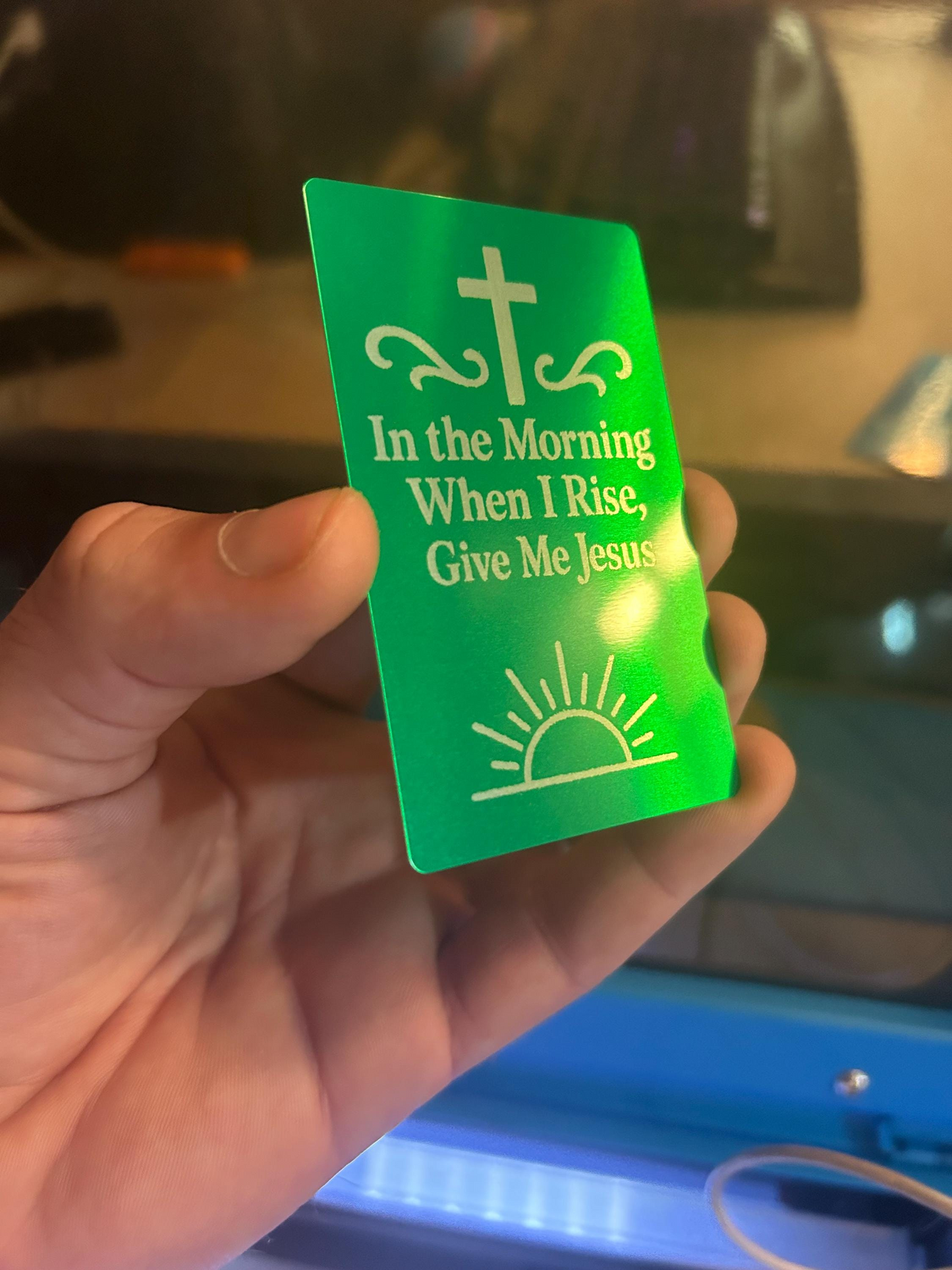 Angled shot of engraved aluminum keepsake card in hand with words “I Wanna Be Where The People Aren’t” – durable metal gift