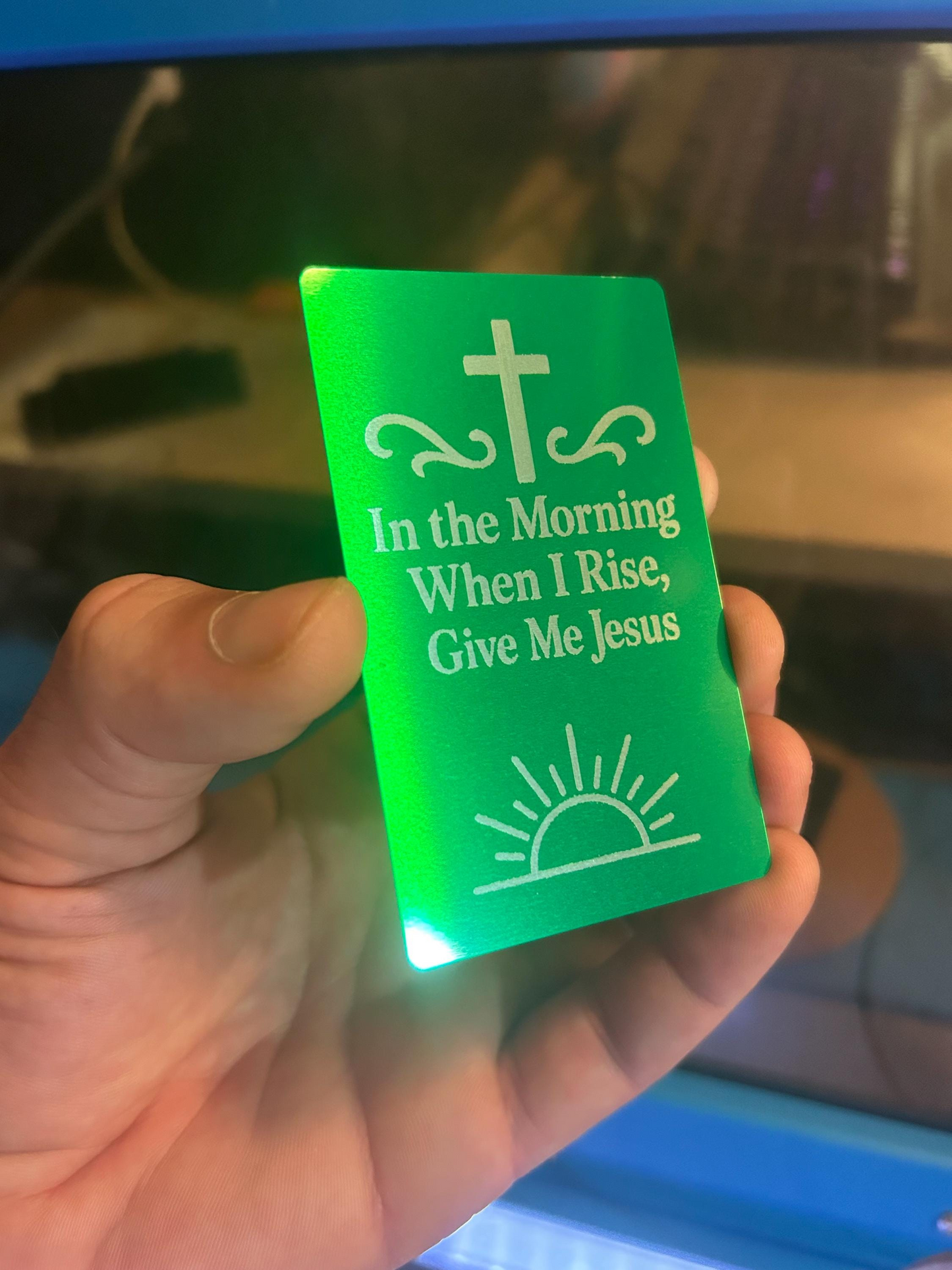 Close-up of hand showing engraved metal keepsake card that reads “I Wanna Be Where The People Aren’t” – unique custom metal bookmark