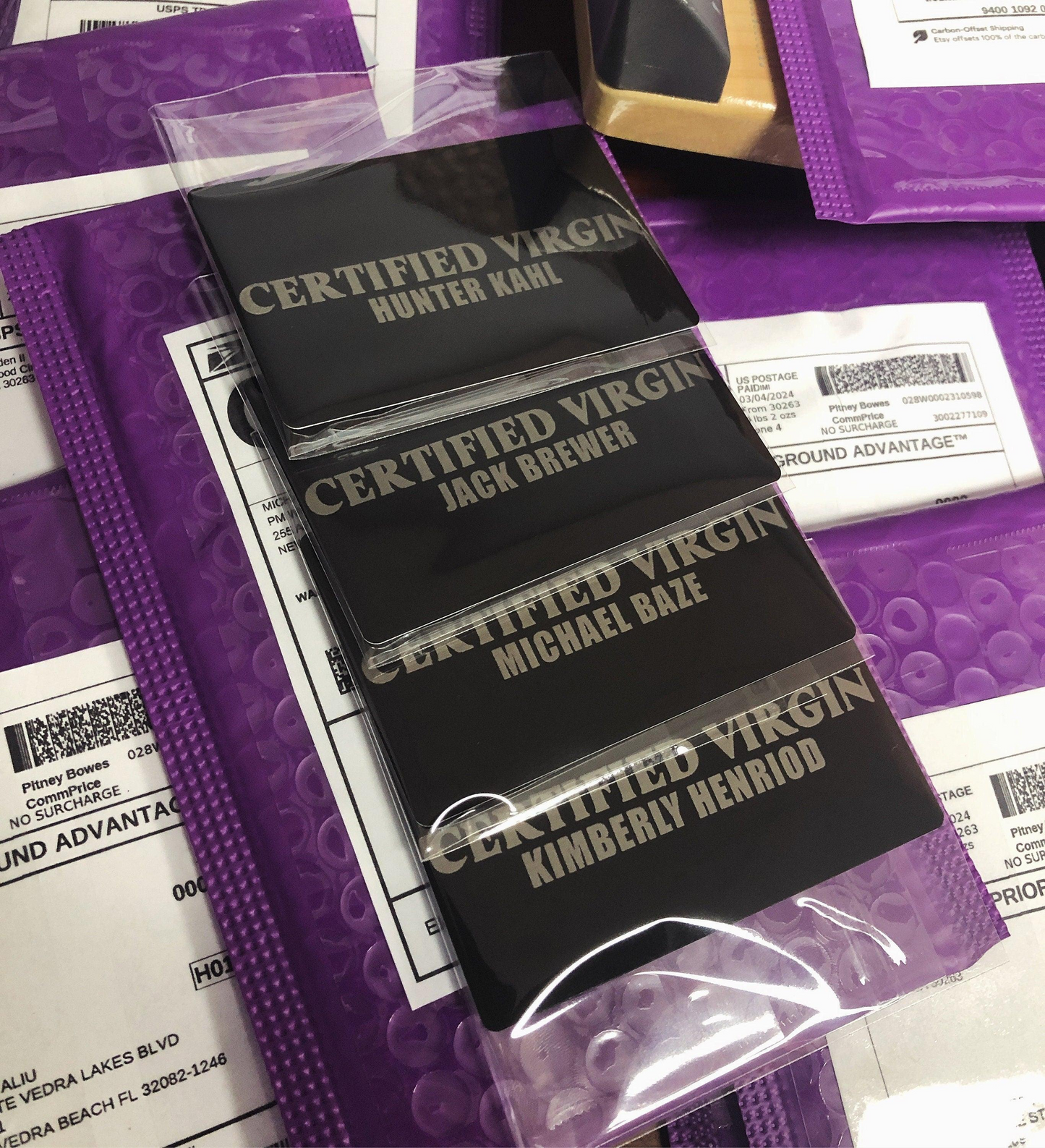 multiple certified virgin laser engraved metal gag gift cards, with custom names against a background of product mailers