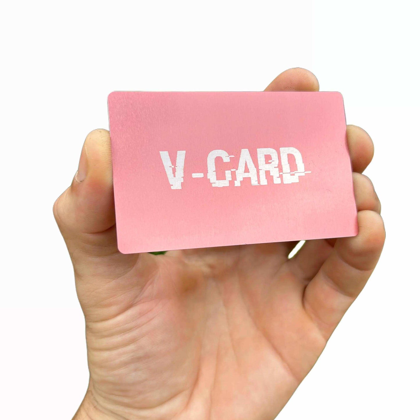 Hand holding a pink card with 'V-CARD' text on a white background