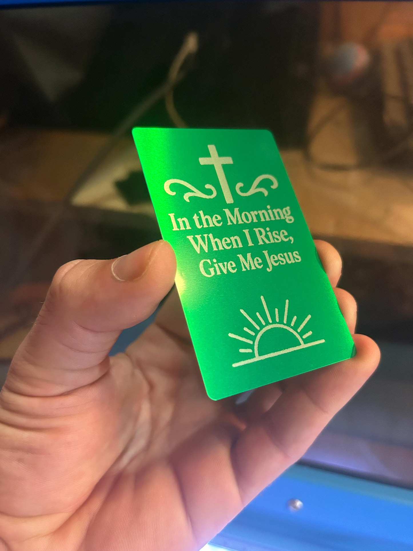 Angled shot of engraved aluminum keepsake card in hand with words “I Wanna Be Where The People Aren’t” – durable metal gift