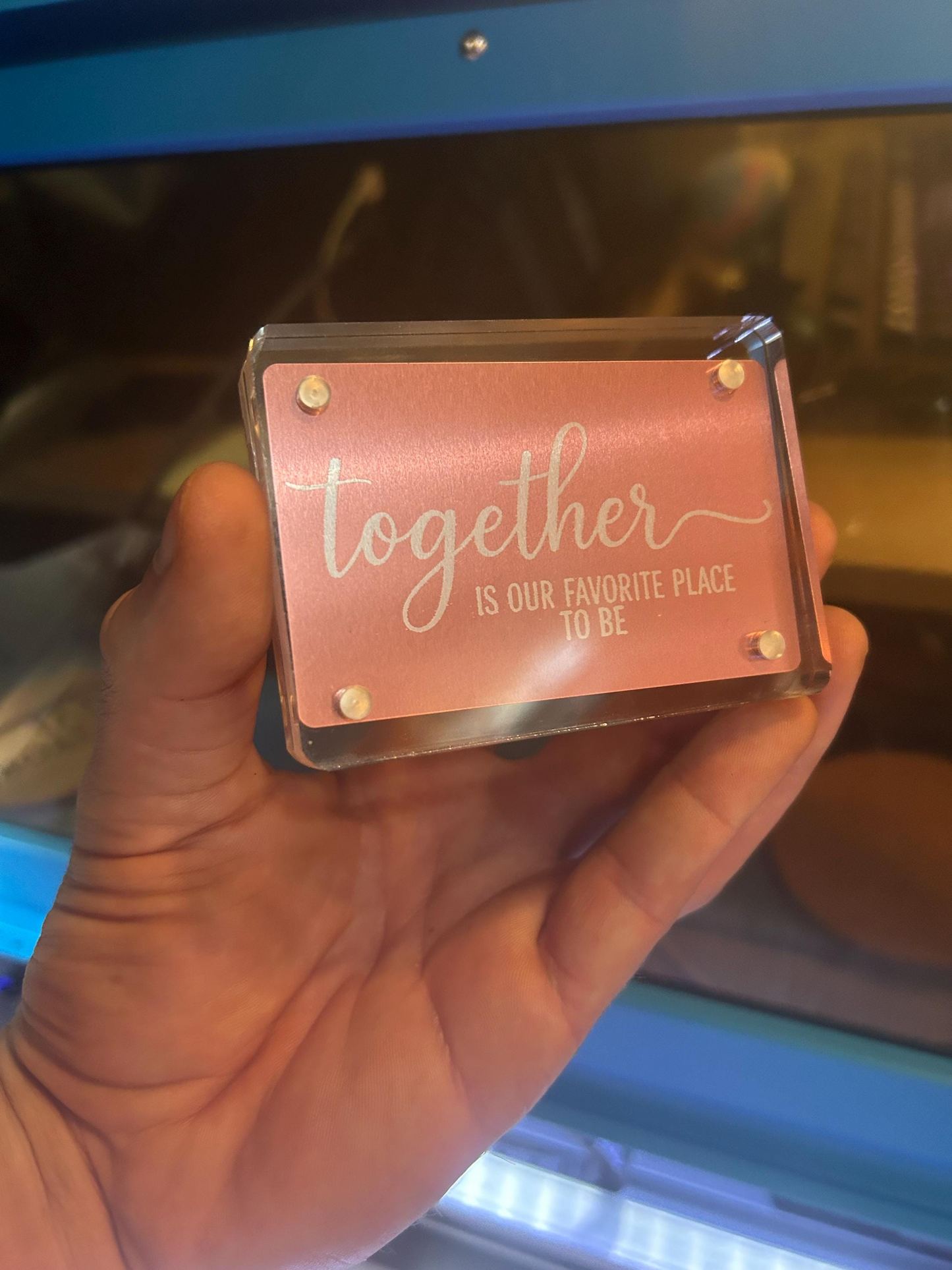 Side angle of engraved rose gold anodized aluminum card featuring “Together Is Our Favorite Place To Be” love message