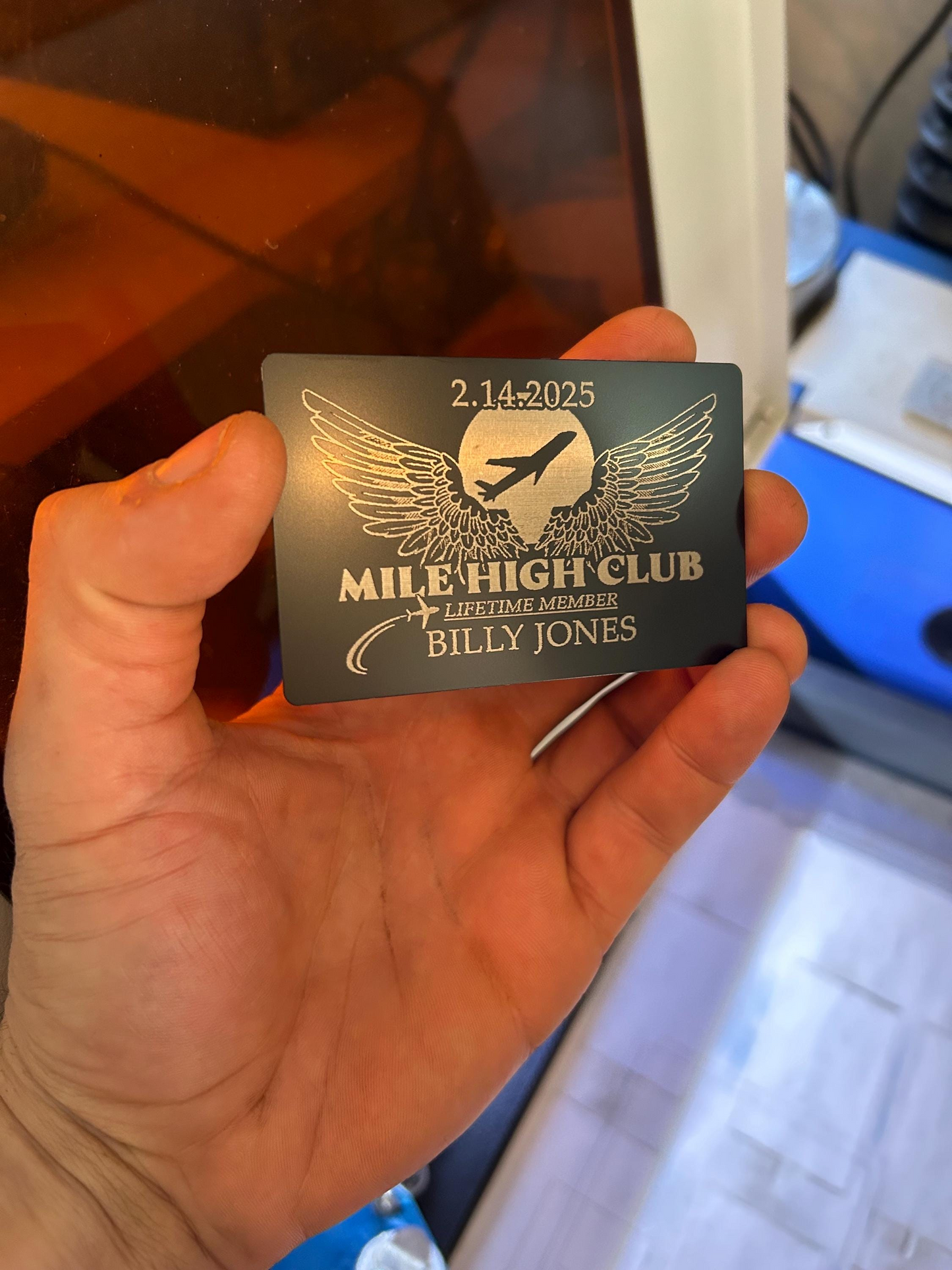 Hand holding a Mile High Club card with personalized details