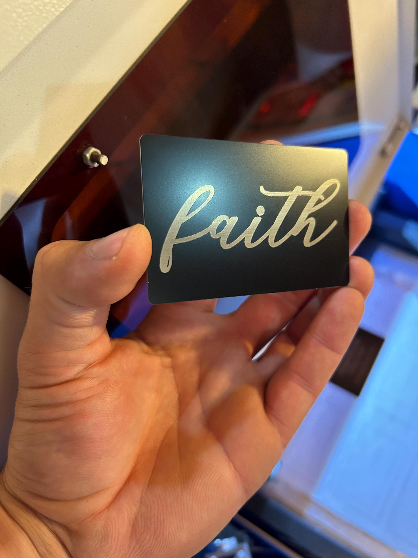 Side angle of metal Christian typography card – engraved cursive “Faith” inspirational design
