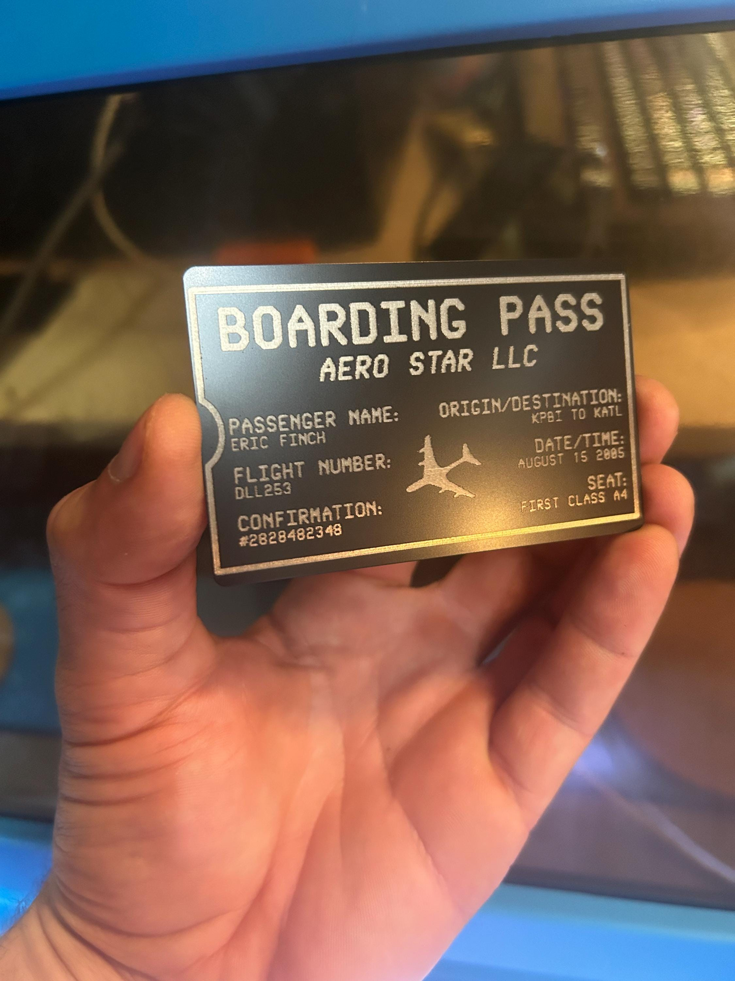 Hand holding a laser engrave metal customized boarding pass ticket keepsake card