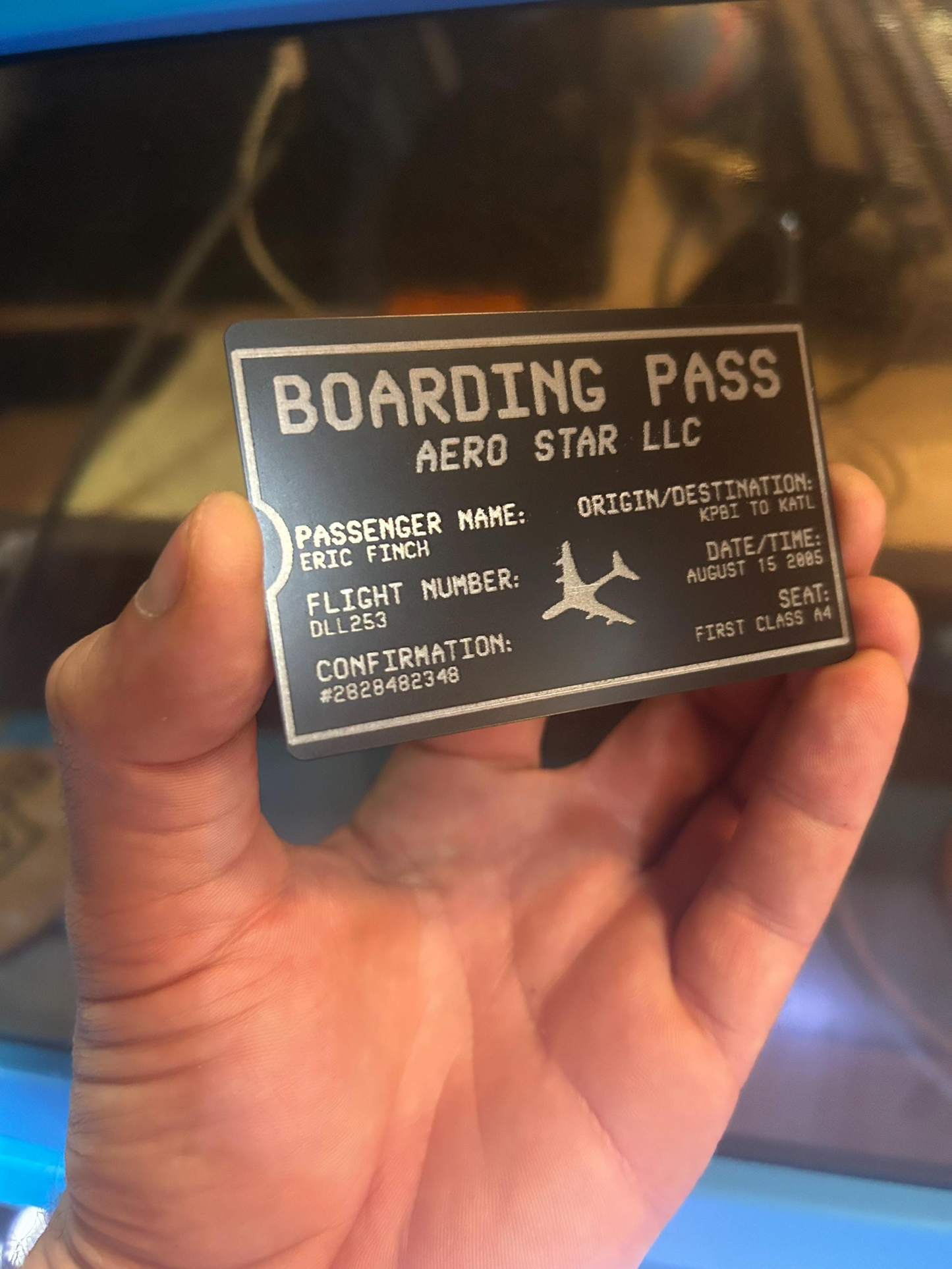 Hand holding a commemorative wallet insert metal badge for special traveling tickets