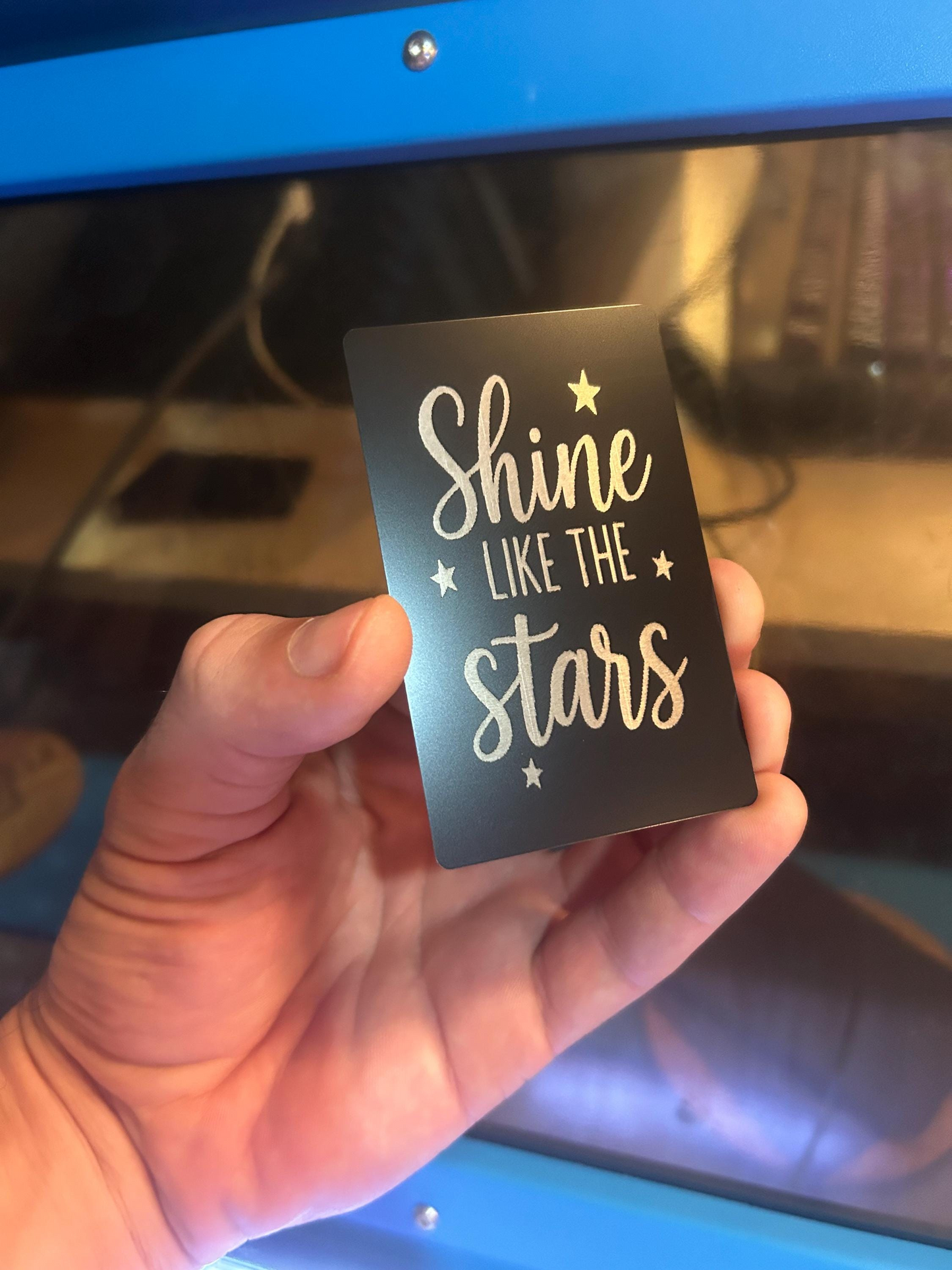 Hand holding metal keepsake gift titled "Shine Like The Stars" novelty wallet insert gift