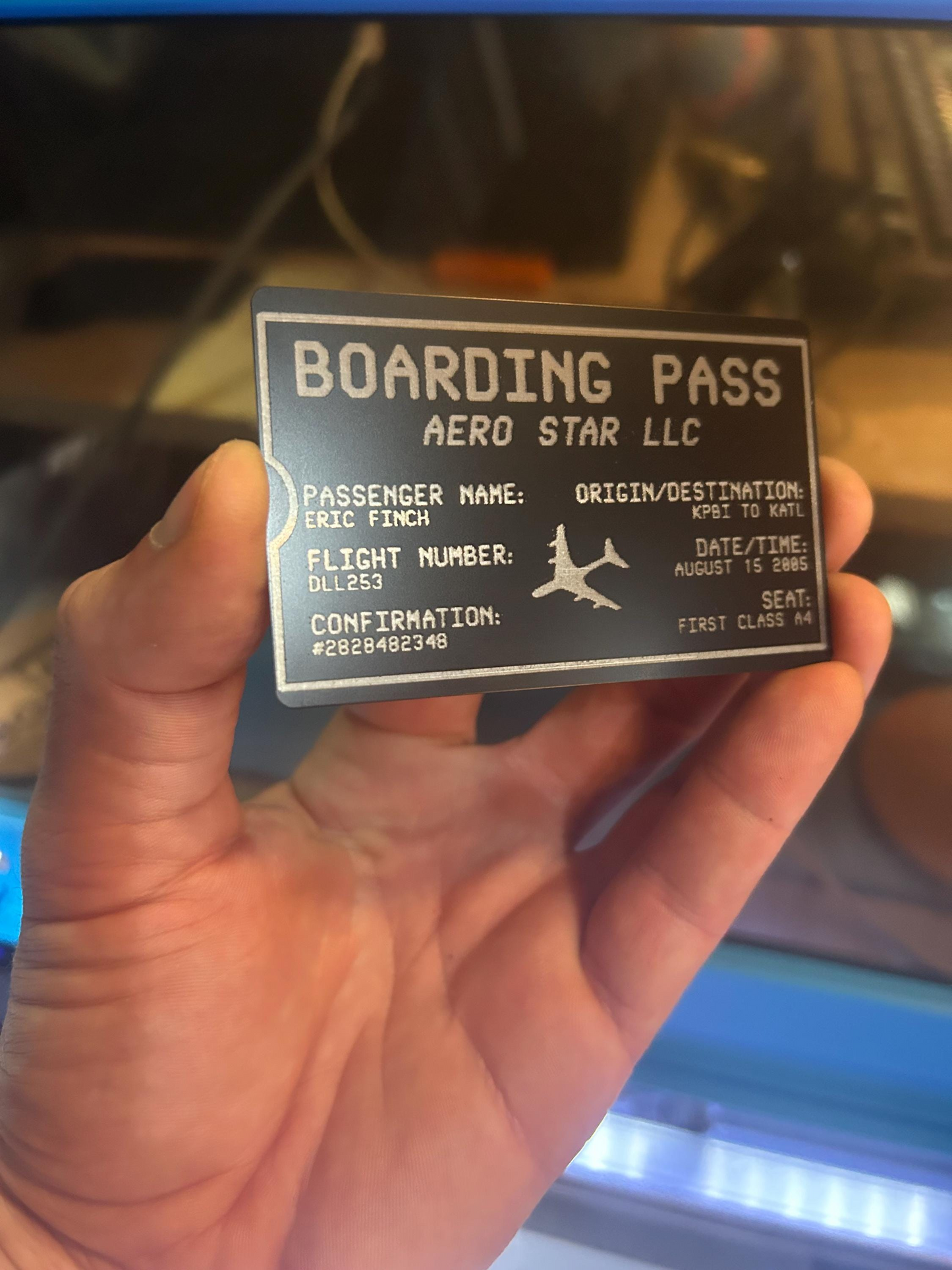 Laser engraved personalized metal boarding pass ticket example with customized text and detailed art