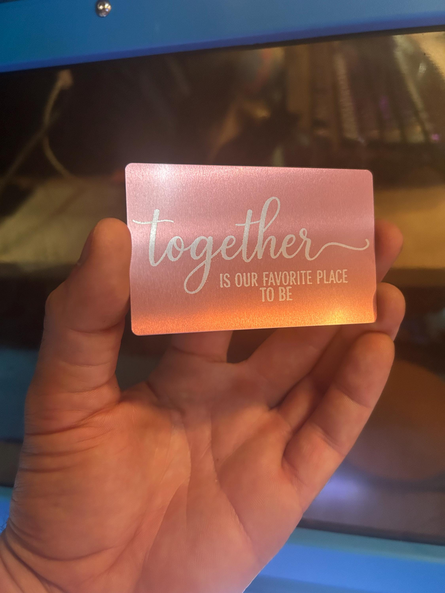 Detailed view of rose gold anniversary keepsake card engraved with “Together Is Our Favorite Place To Be” quote