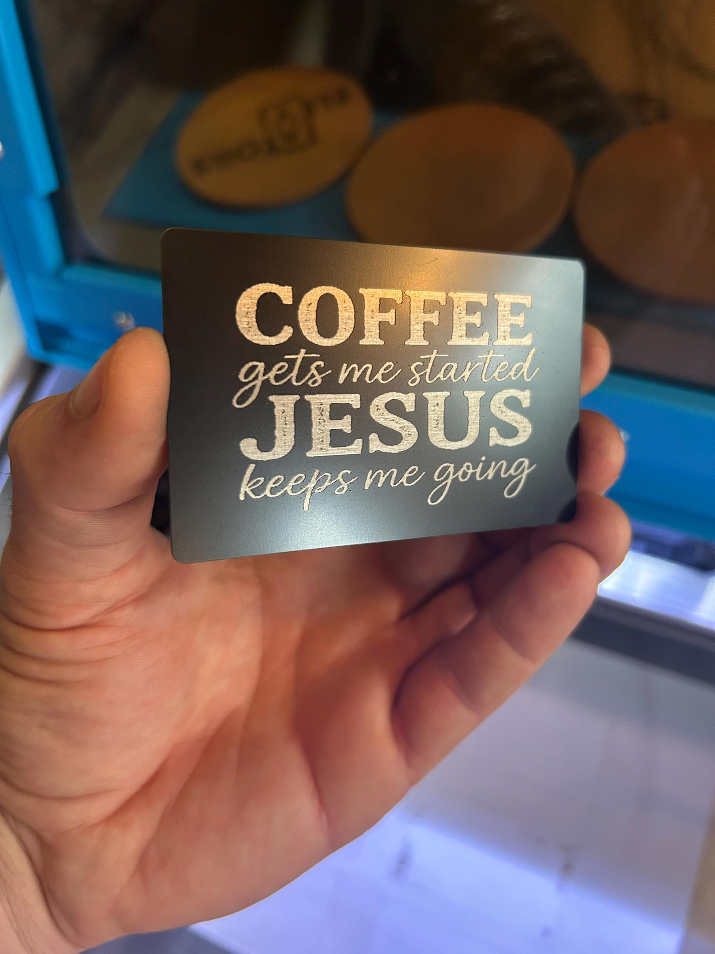 Side angle of laser cut black and silver metal Christian card – “COFFEE gets me started JESUS keeps me going” engraving