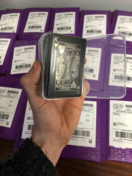 Metal playing card deck with King of Hearts card in black/silver