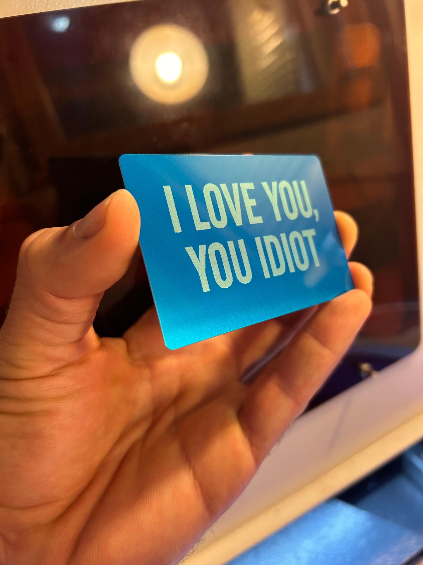 Metal keepsake card with I love you, you idiot typography