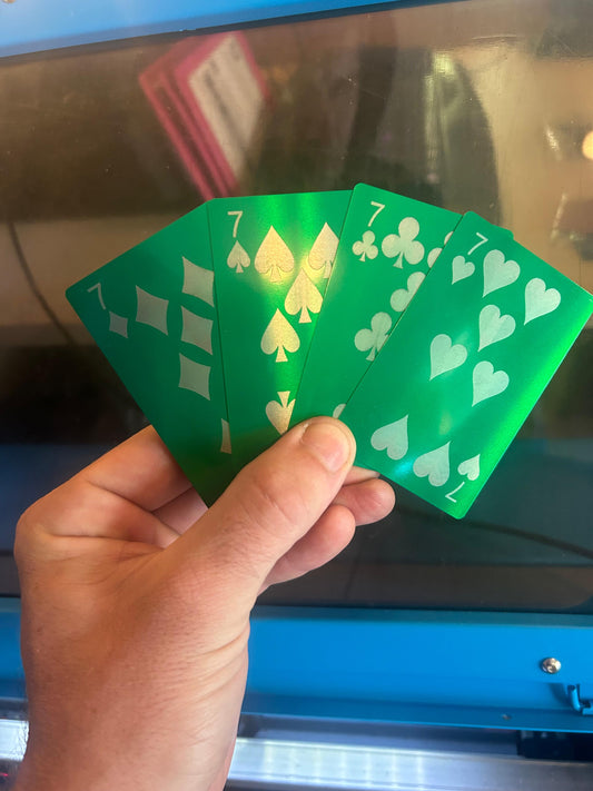 Seven of diamonds, spades, clubs and hearts playing cards in green/silver anodized aluminum