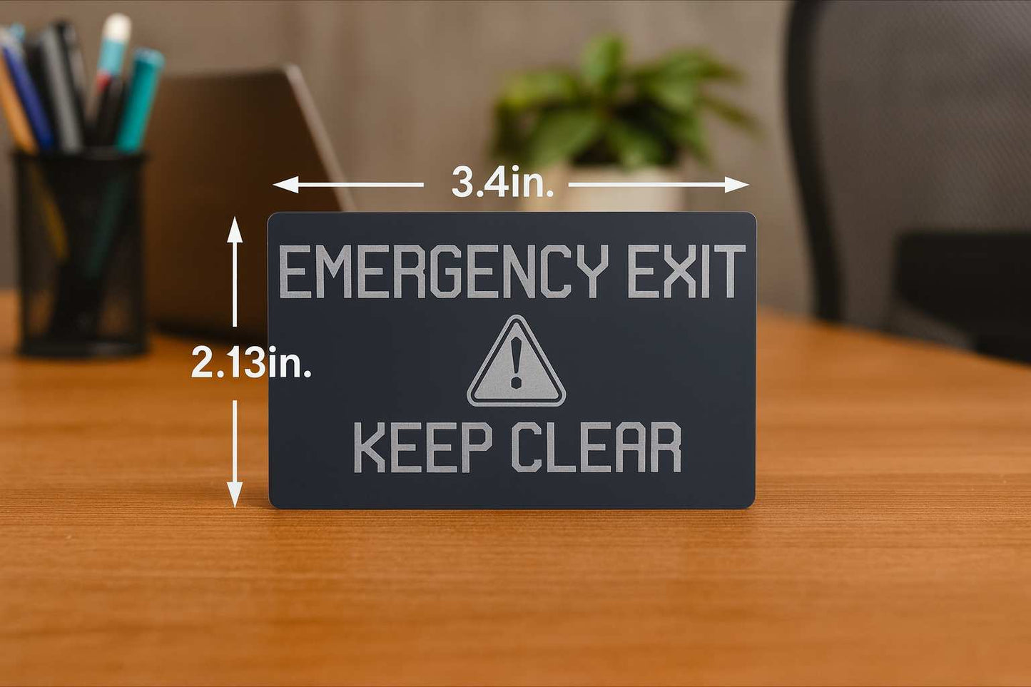 Emergency exit sign with dimensions on a wooden surface