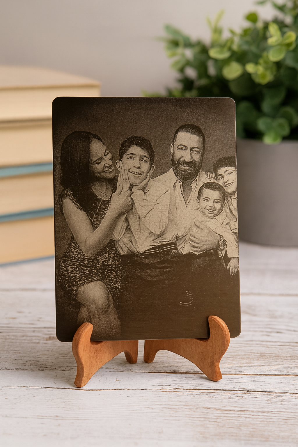 Vintage-style family portrait laser engraved on 5x7 anodized aluminum displayed on a wooden stand with a blurred background