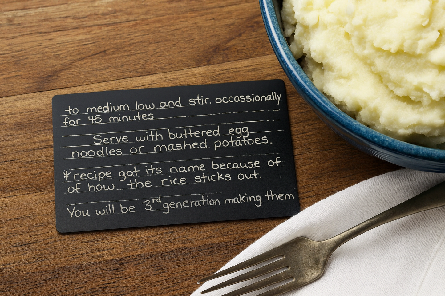 custom handwritten family recipe card, engraved in matte black anodized aluminum product example on kitchen table