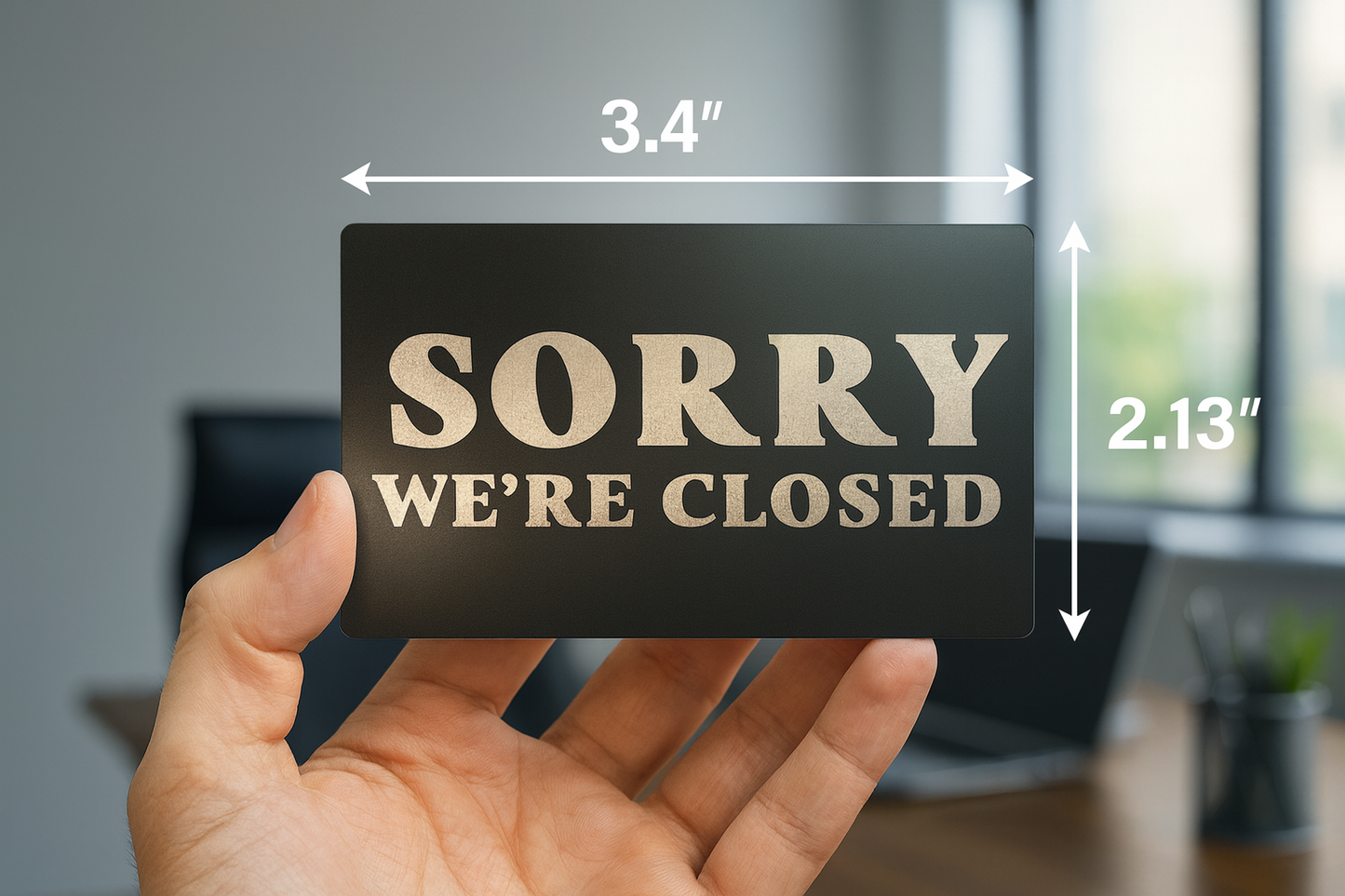 Hand holding a 'Sorry We're Closed' sign with dimensions displayed