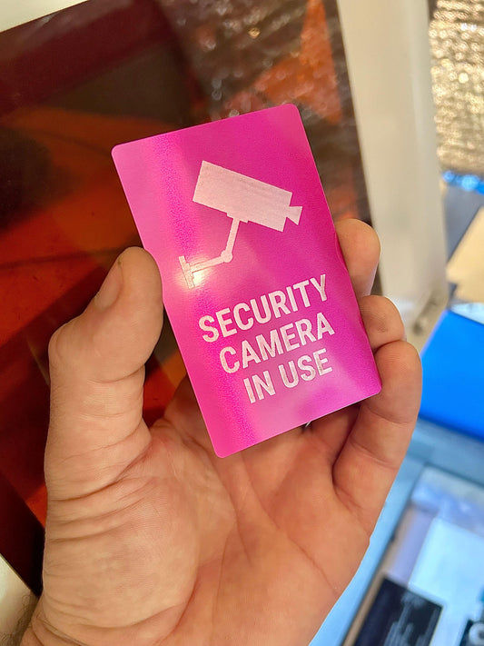 Metal "Security Camera In Use" mini placard in purple/silver anodized aluminum