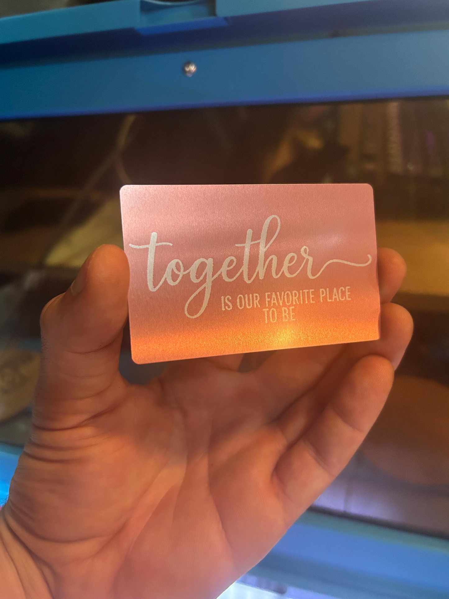 Hand holding romantic engraved rose gold gift card – anniversary keepsake with “Together Is Our Favorite Place To Be” design