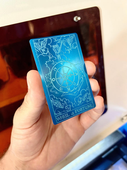 Metal tarot card with Wheel of Fortune laser engraving in blue/silver anodized aluminum