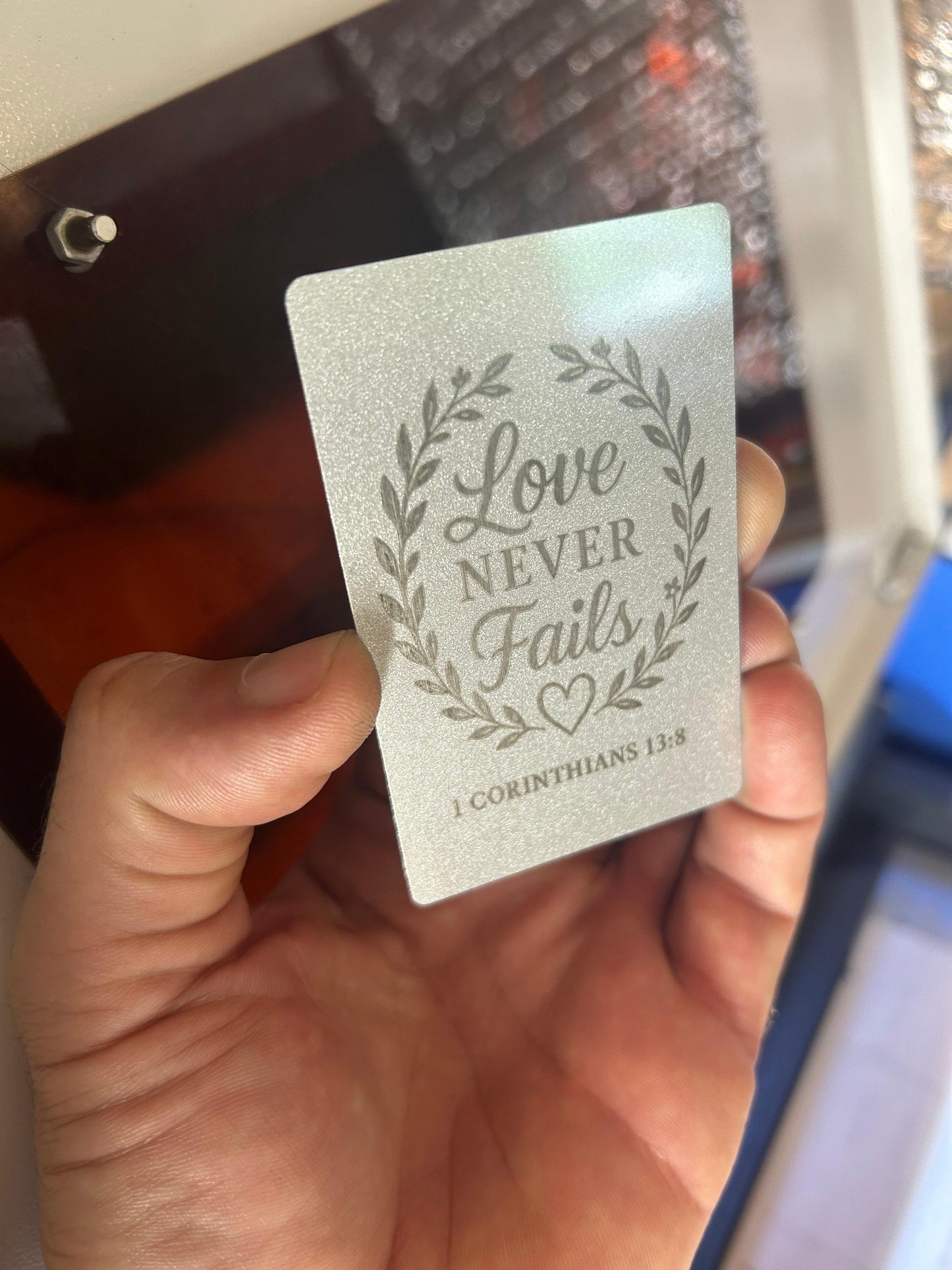 Love Never Fails thoughtful metal keepsake gift card for couples with 1 Corinthians 13:8 bible verse reference below heart artwork