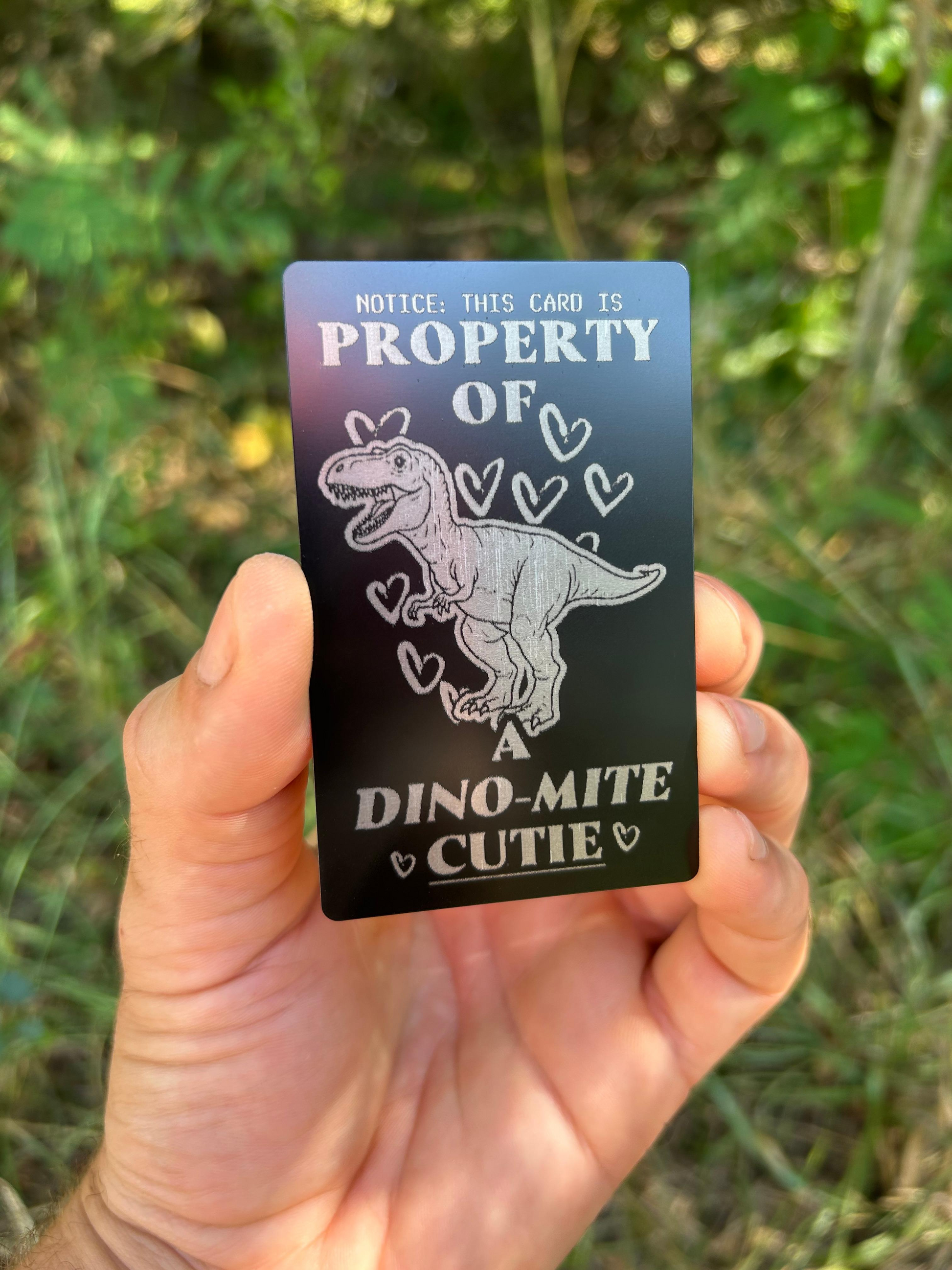 Property of a dynamite cutie play on words metal gift card, romantic -- matte black/silver on green background