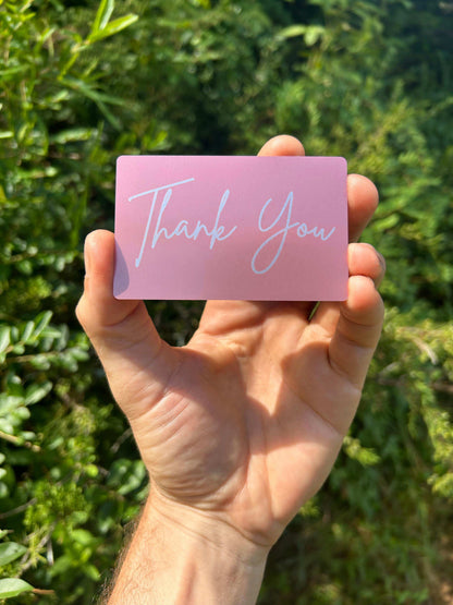 laser engraved rose gold metal gift card insert that says "Thank You" in cursive text, laser engraved on anodized aluminum