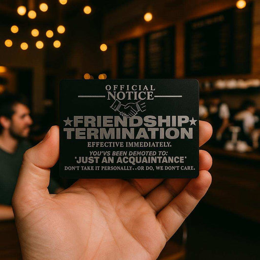 Hand holding a card with 'Official Notice: Friendship Termination' text in a bar setting
