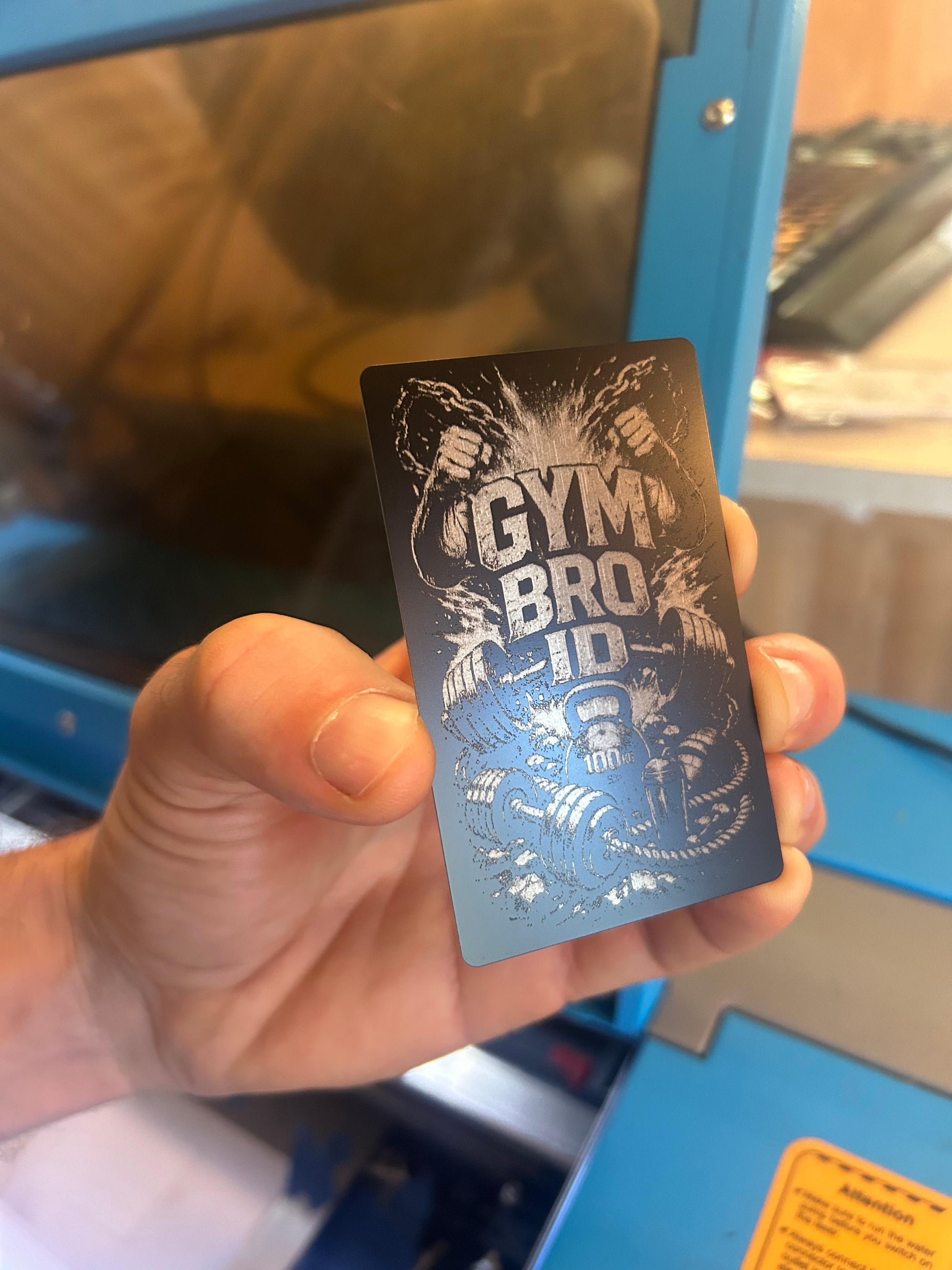 Laser engraved metal Gym ID with weights, chains, protein smoothie and kettle bell illustration