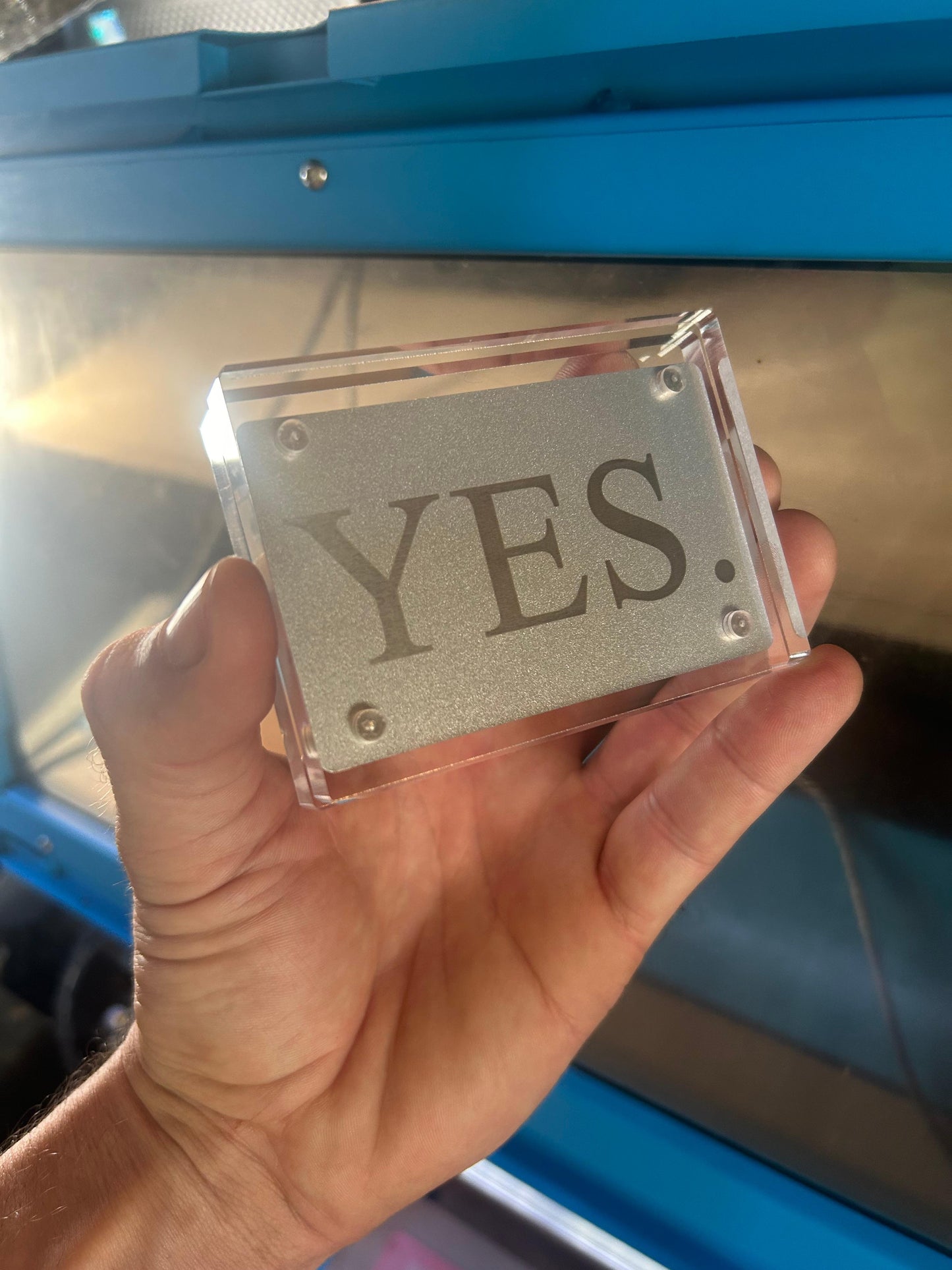 Laser engraved metal YES card in silver/silver displayed in optional acrylic display