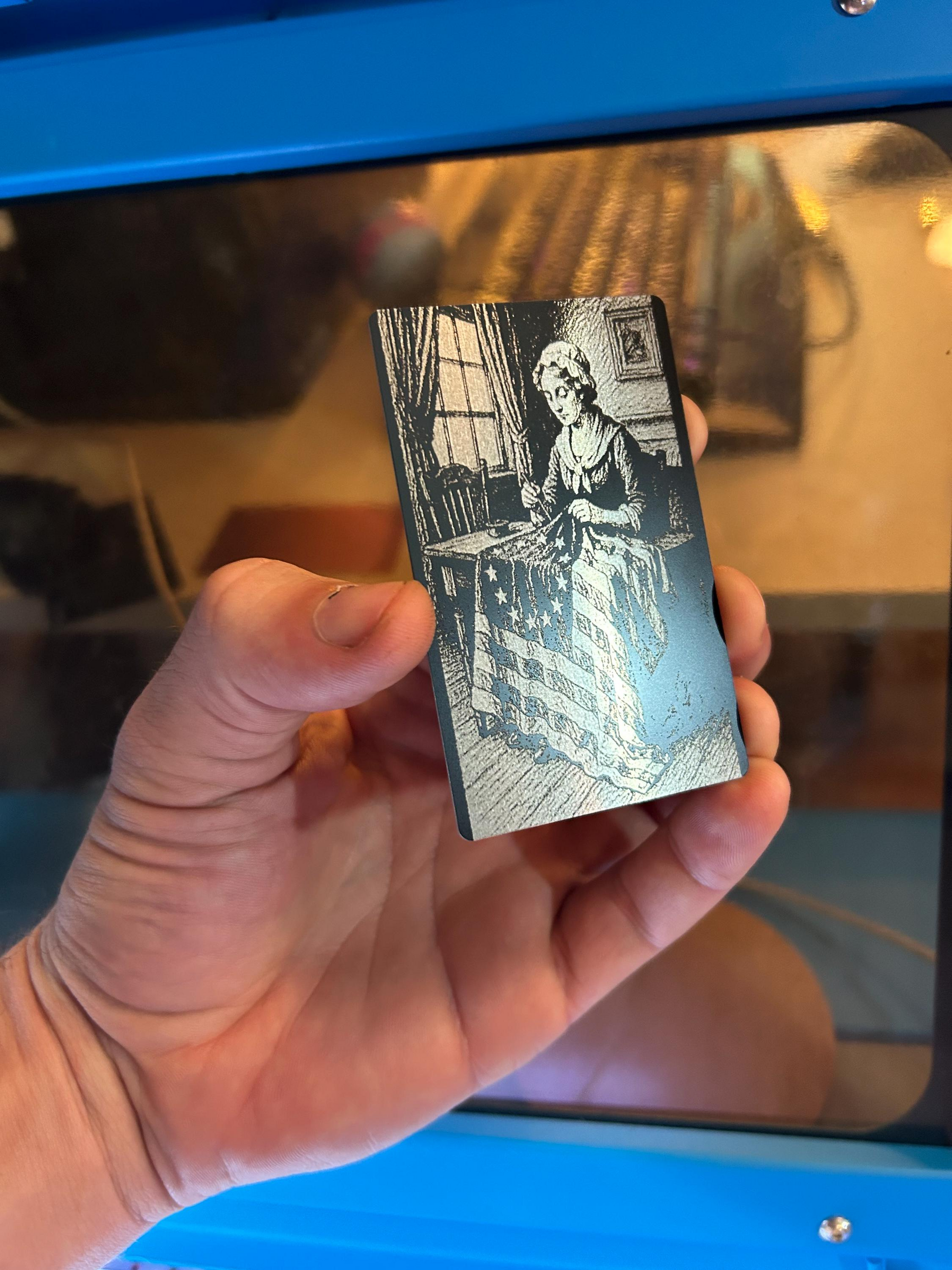 laser engraved anodized aluminum keepsake with american flag and betsy ross sewing illustration