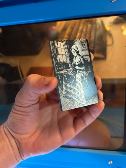 laser engraved anodized aluminum keepsake with american flag and betsy ross sewing illustration