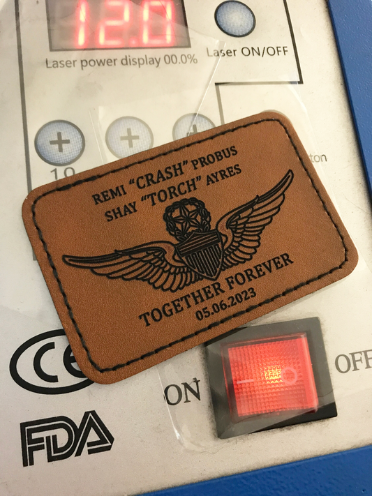 Brown leather patch with personalized commemorative laser engraved text on a device with laser power display.