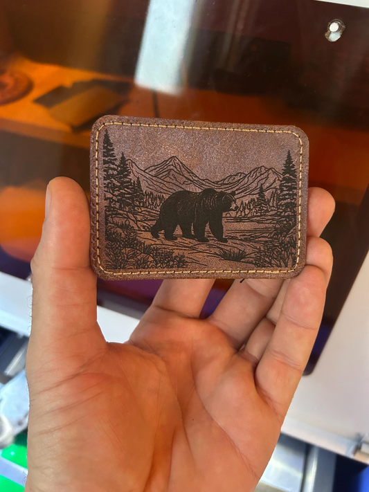 Brown leather patch with detailed brown bear and outdoors mountain design