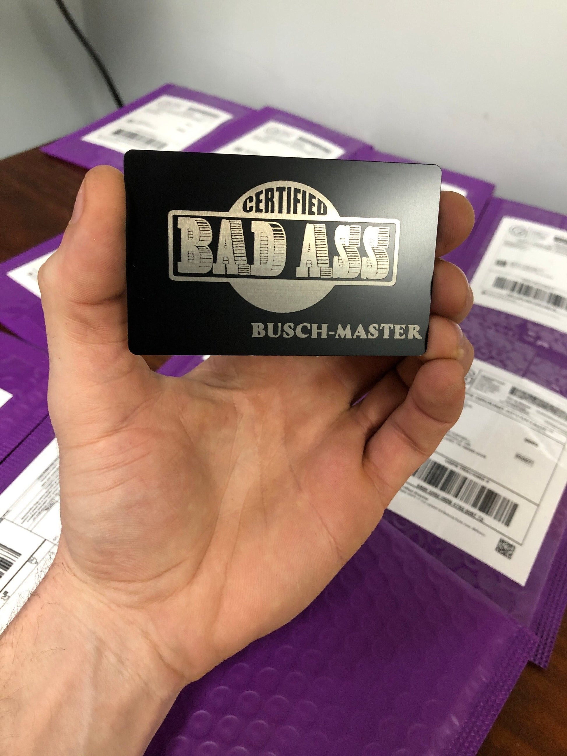 Certified Bad Ass metal ID badge with customized text laser engraved below in black/silver anodized aluminum