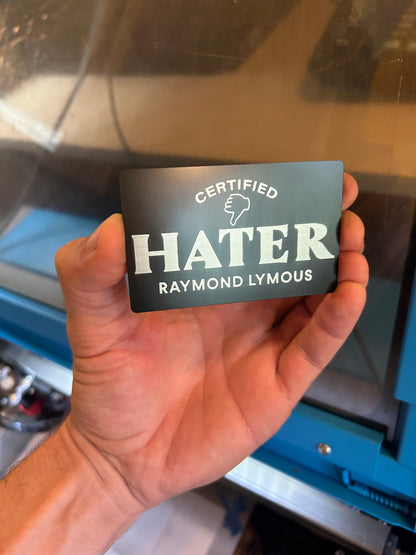 Metal "Certified Hater" card with personalized name engraved below