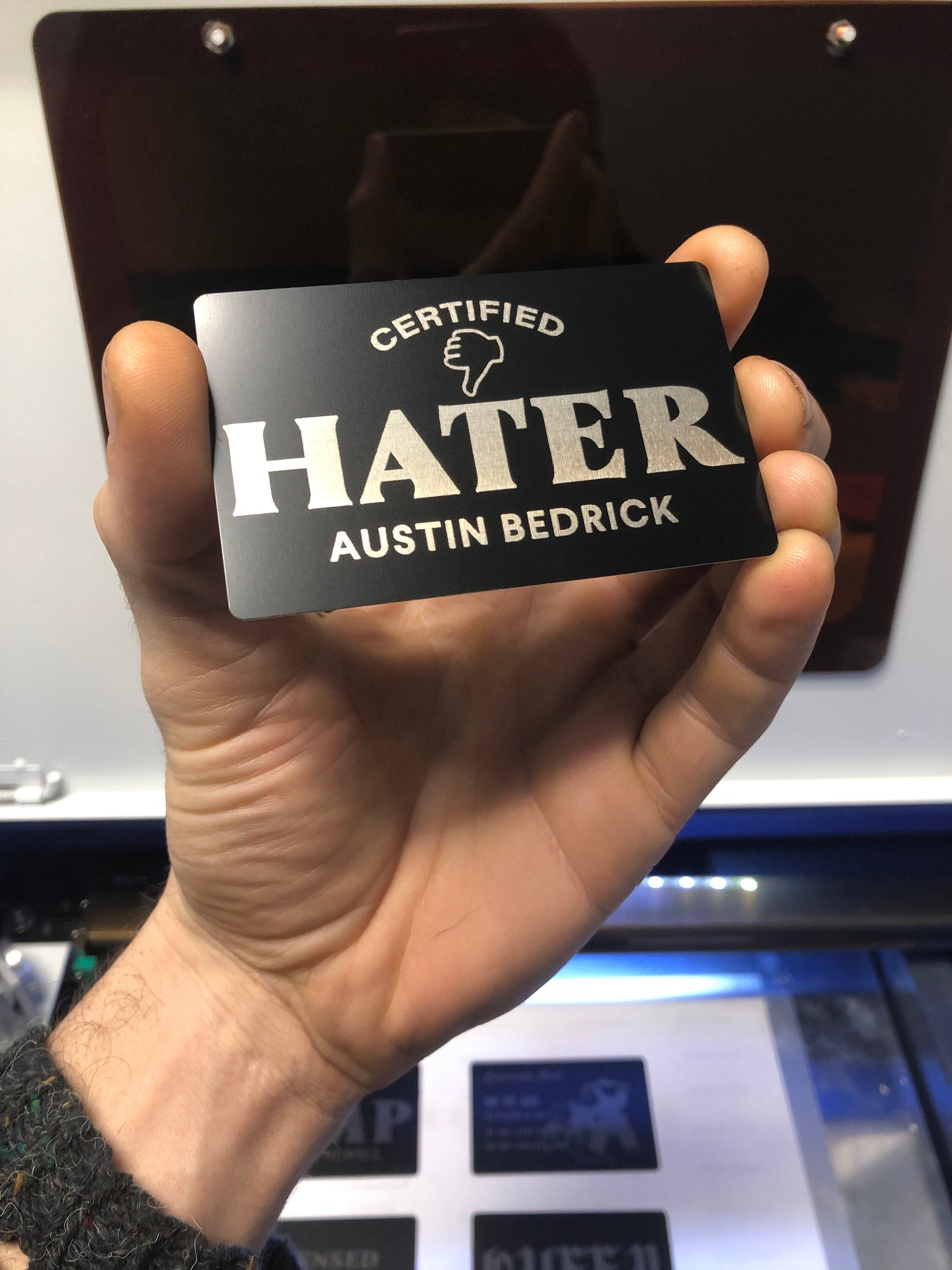 Laser engraved metal gift card with Certified Hater and customized name engraving below in black/silver