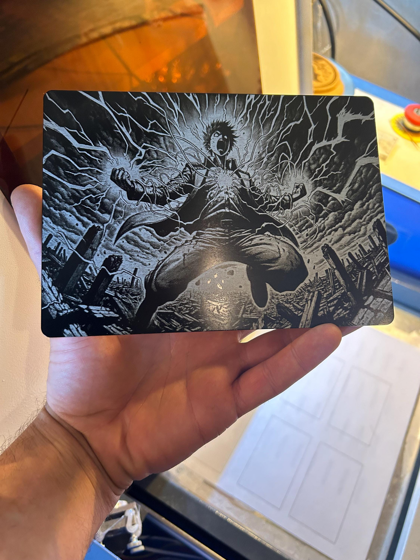 Metal 7x5" plaque with black and white manga illustration of a character holding a sword, held by a person.