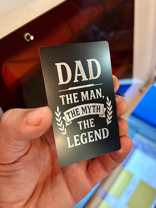 Laser engraved metal keepsake card that reads Dad: The Man The Myth The Legend laser engraved in black/silver anodized aluminum