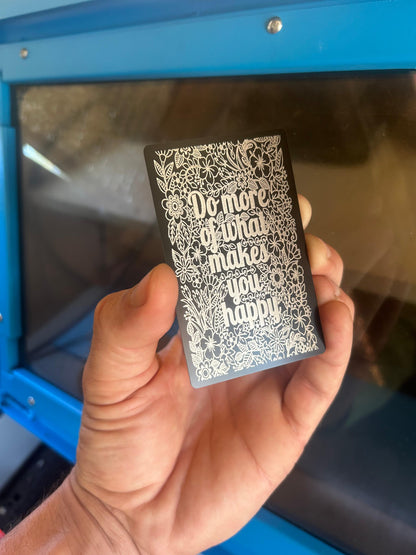 Laser engraved metal affirmation keepsake card with Do More of What Makes You Happy design in black/silver