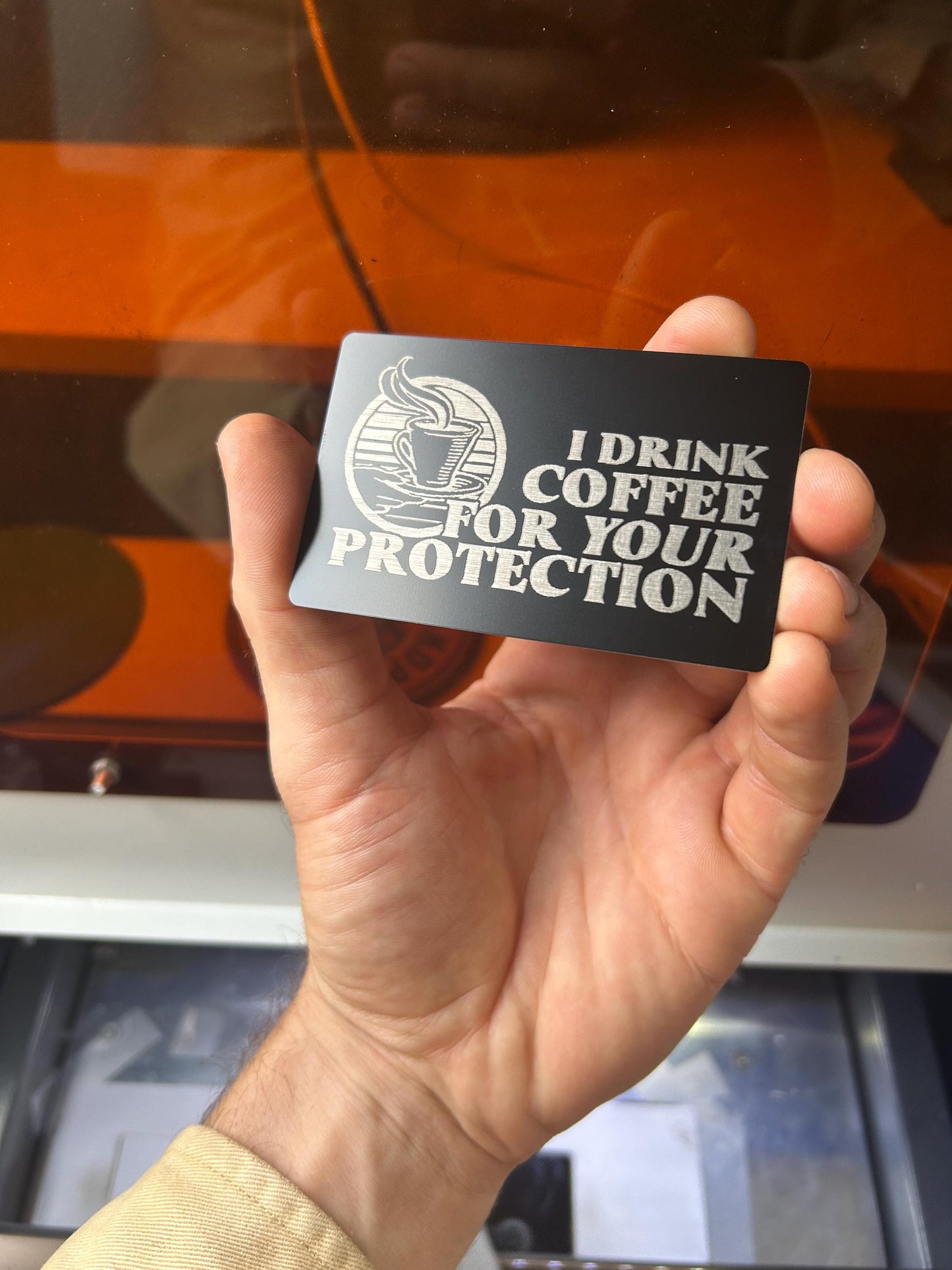 Metal "I Drink Coffee For Your Protection" laser engraved metal keepsake card in black/silver