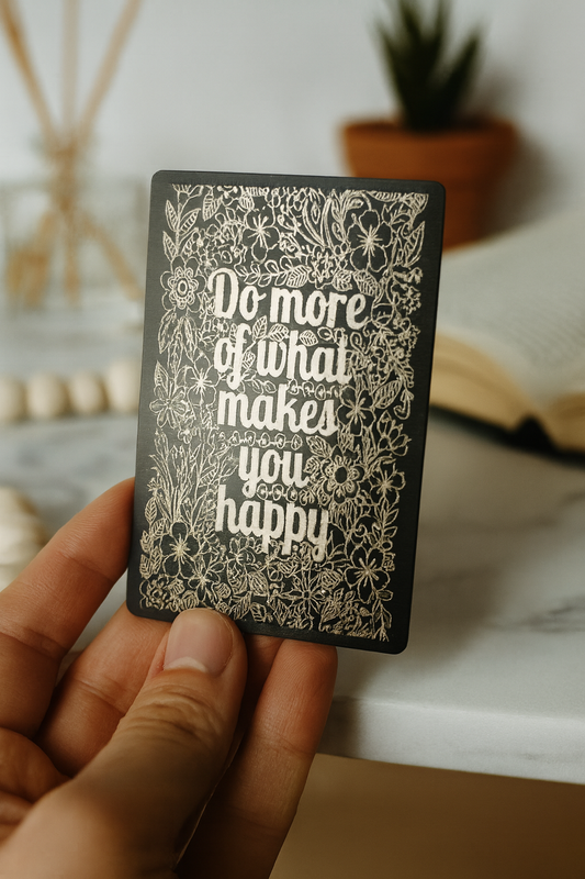 Hand holding a metal novelty faith affirming keepsake card with decorative motivational text and floral patterns