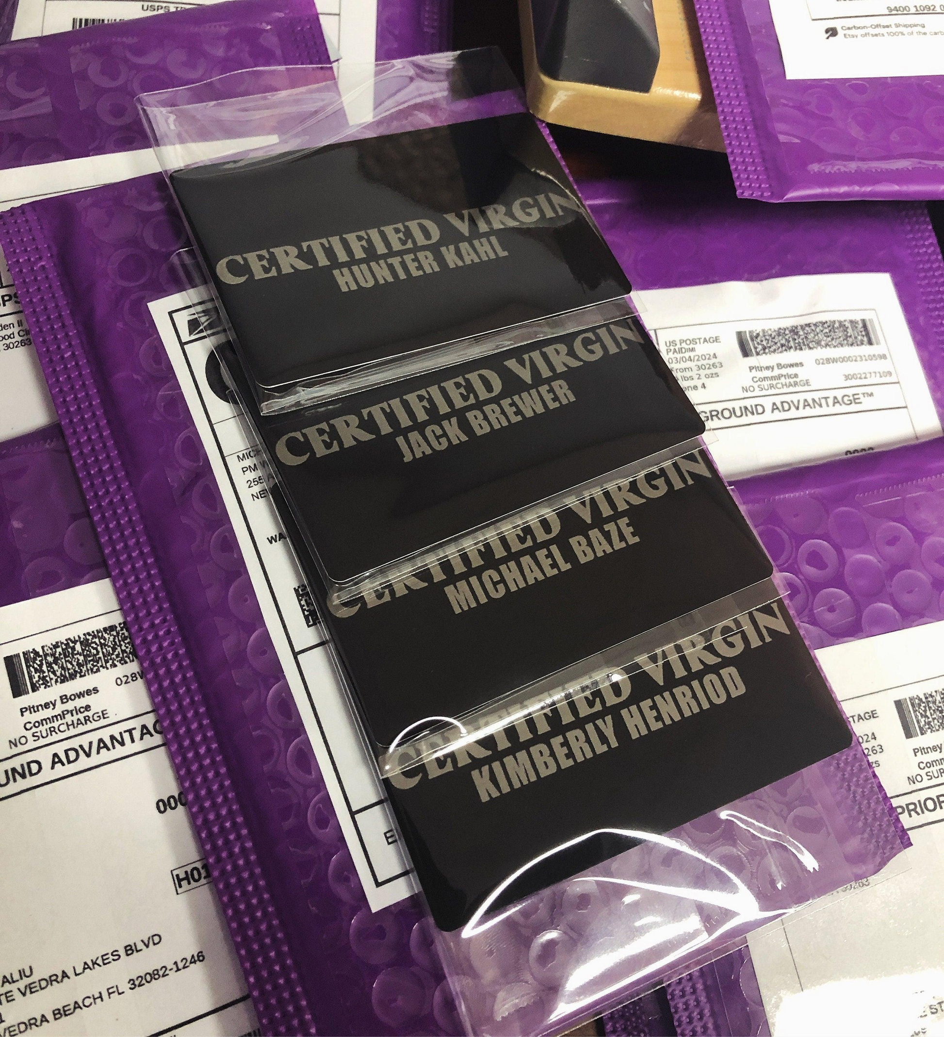 multiple certified virgin laser engraved metal gag gift cards, with custom names against a background of product mailers