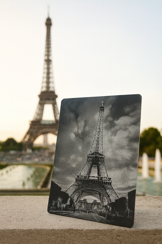 Notebook with Eiffel Tower design in front of the actual Eiffel Tower