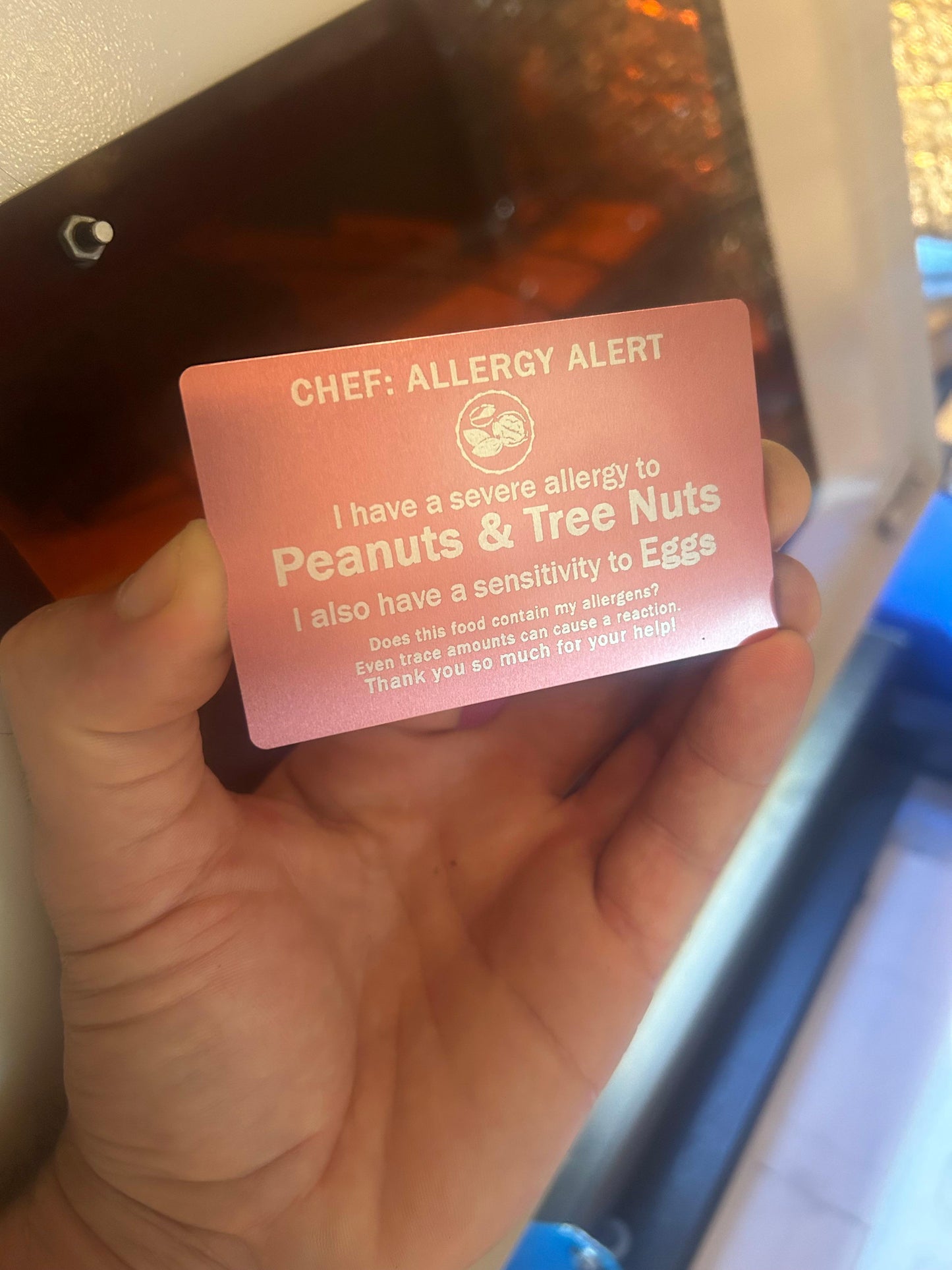 Metal food allergies card with customized text engraving showing food allergy and sensitivity information for eating at new restaurants