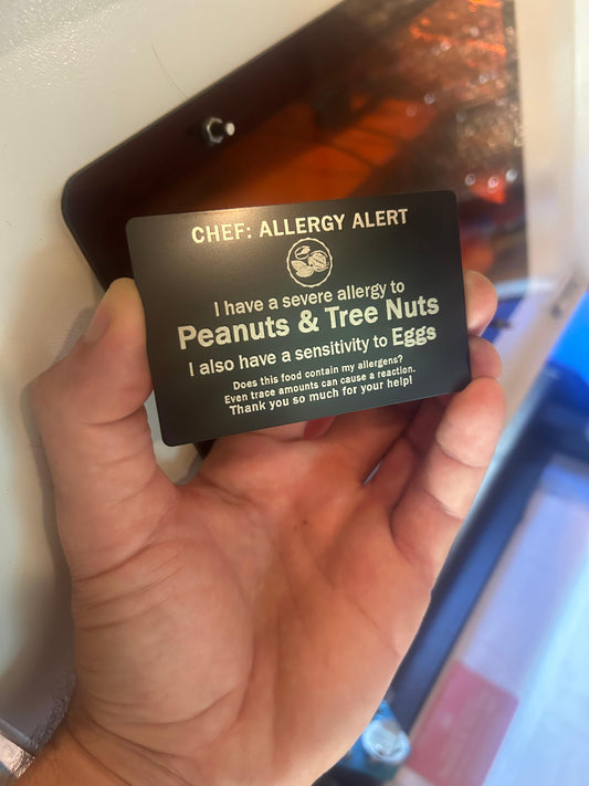 Metal food allergies card with personalized text engraving for travel and safe eating at new restaurants, shown in black/silver