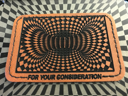 Brown leather patch with a geometric pattern and 'For Your Consideration' text on a checkered background