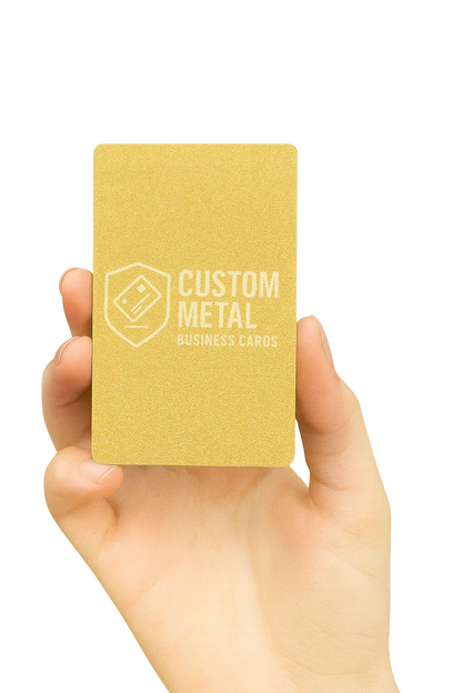 Hand holding a gold metal business card with 'Custom Metal Business Cards' text on a white background